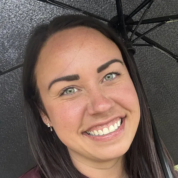 Breanne Su’a, Bestie Squad member, smiling under an umbrella